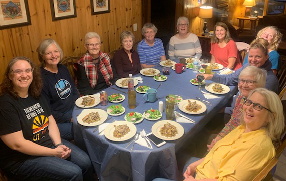 Smiling 2021 retreat participants at dinner